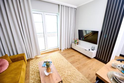 a living room with a couch and a table at Babichy 29 DOM Apartamenty MANDORIA , Rodzina , Family , Orientarium , PTAK , Parking bezpłatny in Babichy