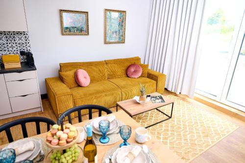a living room with a couch and a table at Babichy 29 DOM Apartamenty MANDORIA , Rodzina , Family , Orientarium , PTAK , Parking bezpłatny in Babichy