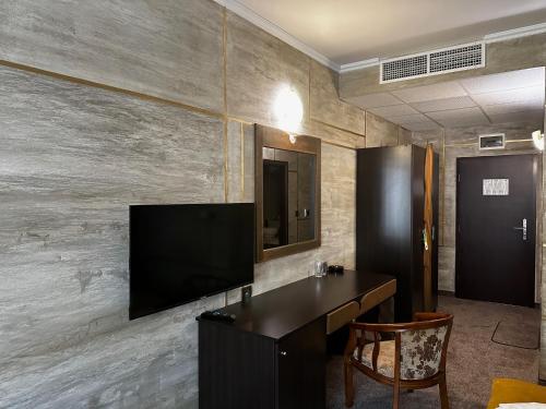 a room with a television on a wall at Art Hotel Babylon in Sunny Beach
