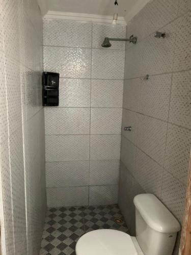 a small bathroom with a toilet and a shower at @BeachHouseItamaraca in Itamaracá