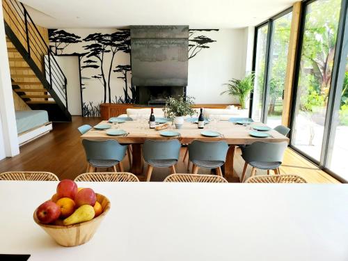 a dining room with a table with a bowl of fruit at Luxury Bali Villa in Hossegor 5 stars- Pool & Petanque in Hossegor