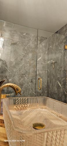 a bathroom with a shower with a glass door at Refreshing POOL Old Town Scottsdale 4 Bdr 3 FULL Baths in Scottsdale