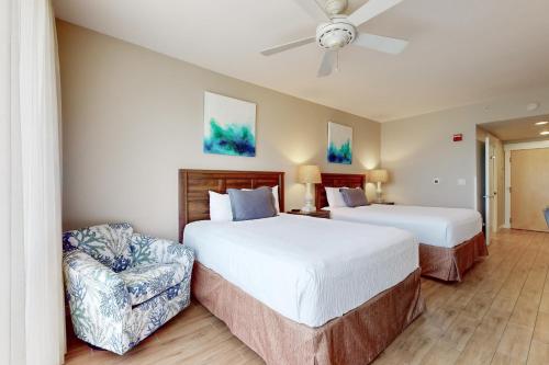 a hotel room with two beds and a chair at Elation #5216 in Destin