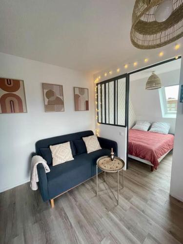 una sala de estar con un sofá y una cama en Studio Vue Mer, en Villers-sur-Mer
