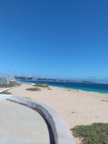 a sandy beach with the ocean in the background at Casa Nahuel in Algarrobo