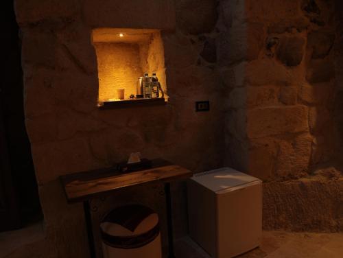 a stone bathroom with a sink and a toilet at Hira Cave Hotel in Goreme