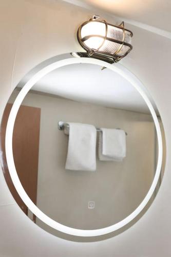 a mirror in a bathroom with two white towels at Titinas' in Plomari
