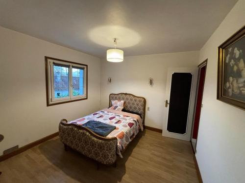 un dormitorio con una cama y una ventana en Agréable maison de ville avec tout à proximité, en Saint-Dizier
