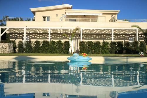 a blue toy in the water in front of a building at SUNSEA - Enjoy Your Family in Capo Vaticano