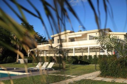 a house with a pool in front of it at SUNSEA - Enjoy Your Family in Capo Vaticano