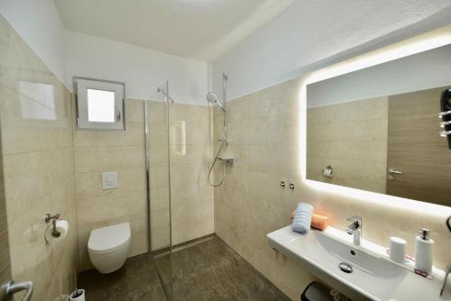 a bathroom with a toilet and a sink and a shower at Apartments Petarcica Beach in Zavala