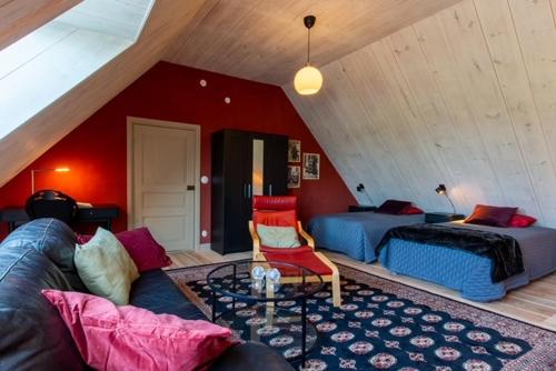 a living room with a couch and a bed at Ängaröds Gård in Ljungbyhed