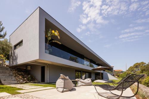 a house with a large window on the side of it at Just Like Home - Casal no Campo in Vila Praia de Âncora