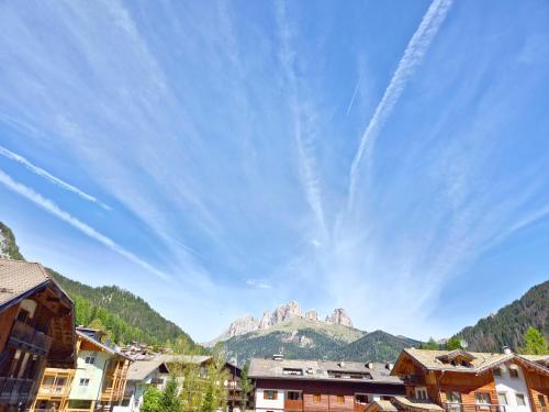 a view of a mountain from a town with houses at Appartamenti Villa Flora by AMA Val di Fassa in Canazei