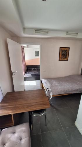 a room with a bed and a desk and a table at Apartments Londa in Jūrmala