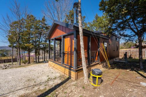 a tiny house with a tree at Cabin 1 Indian Point near SDC, Table Rock Lake, Marinas, & Branson in Branson