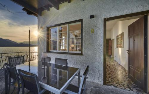 a building with chairs and a door with a view of the water at Villa Scoglio in Varenna