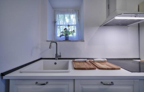 a kitchen counter with a sink and a window at Villa Scoglio in Varenna