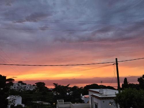a sunset from the roof of a house at Il Portico B&B Capri in Capri