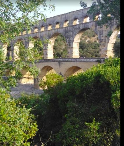 an old stone bridge with arches on it at Meublé pont du Gard 4 personnes in Remoulins