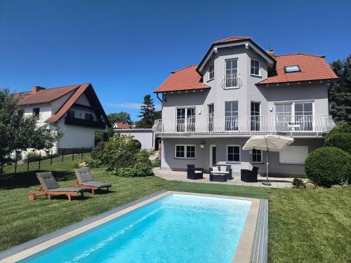 a house with a swimming pool in front of a house at Idyllische Lage im Süden Erfurts in Erfurt