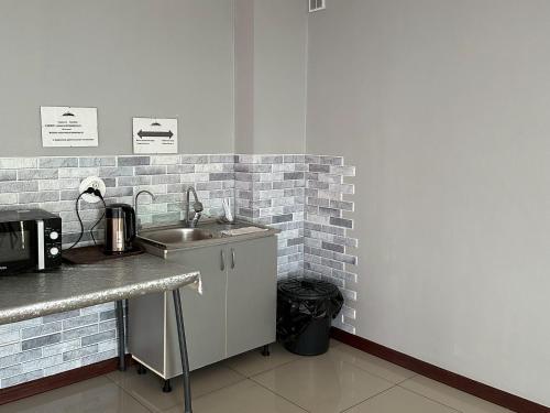 a kitchen with a sink and a counter top at DDHotel in Almaty