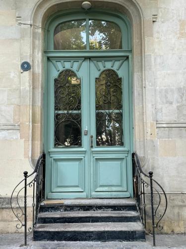a blue door on a building with stairs at Zimmer Boutique Hotel in Baku