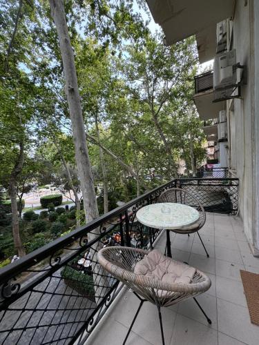 a patio with a table and chairs on a balcony at Zimmer Boutique Hotel in Baku
