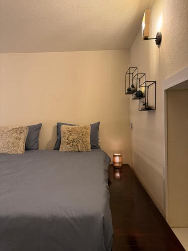 a bedroom with a bed with blue pillows at Zimmer Boutique Hotel in Baku