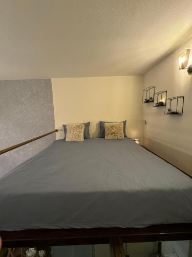 a bedroom with a large bed with two pillows at Zimmer Boutique Hotel in Baku
