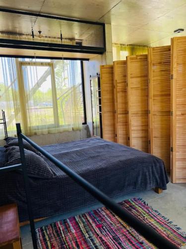 a bedroom with a bed and some wooden cabinets at Nina's house & Yard 200m from beach Kaprovani in Ureki