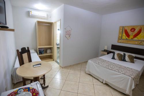 Postel nebo postele na pokoji v ubytování Hotel Pousada das Flores