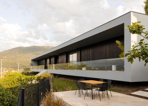 ein Haus mit einem Tisch und Stühlen davor in der Unterkunft Just Like Home - Casal no Campo in Vila Praia de Âncora