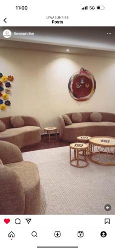 a living room with two couches and a table at Liwa sunrise Farm in Sabkhah