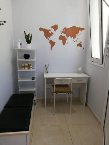 a desk with a world map on a wall at The yard in Thérissos
