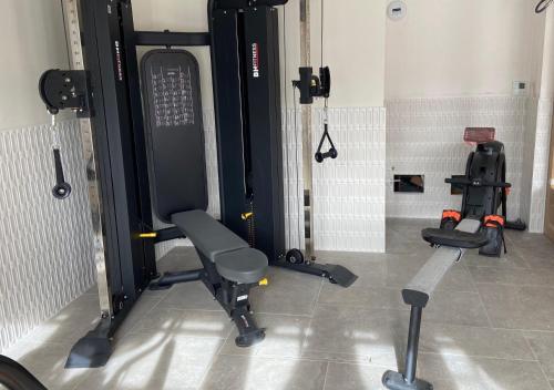 a room with a gym with a chair and weights at Hotel Mendionde in Saint-Pée-sur-Nivelle