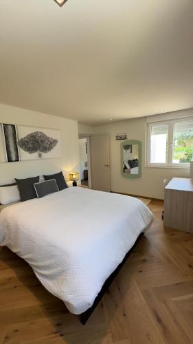 a bedroom with a large white bed in a room at La Lunita in Santa Eularia des Riu