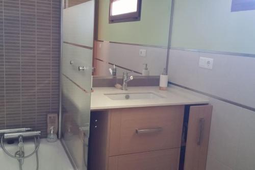 ein Badezimmer mit Waschbecken und Spiegel in der Unterkunft Casa da Ameixida in Ribeira