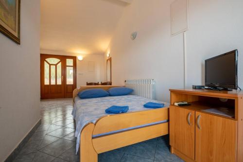 a bedroom with a bed and a flat screen tv at Villa Nikola in Neum