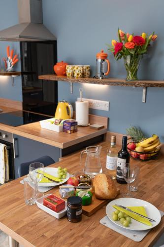 a table with plates of food on top of it at Fabulous apartment for 2 in Llansteffan in Llanstephan