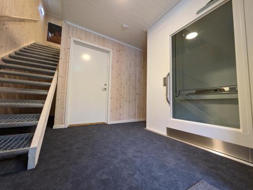 a room with a staircase and a door and a stair case at Villa Fregn in Ljørdal