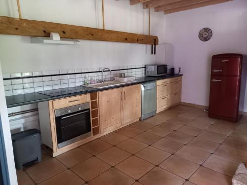 une cuisine avec un évier et un réfrigérateur dans l'établissement Chez Candice et Pascal gîte 1, à Lauraët