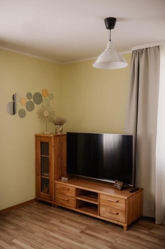 a living room with a large flat screen tv at Saules iela 2A in Saldus