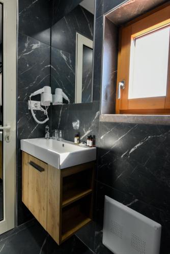a bathroom with a sink and a mirror at Villa Loredan in Shkodër