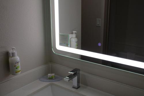 a bathroom with a sink with a large mirror at Baymont Inn & Suites San Marcos in San Marcos