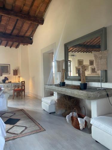 a living room with a large mirror and a couch at PodereVicoBasso Siena in Siena