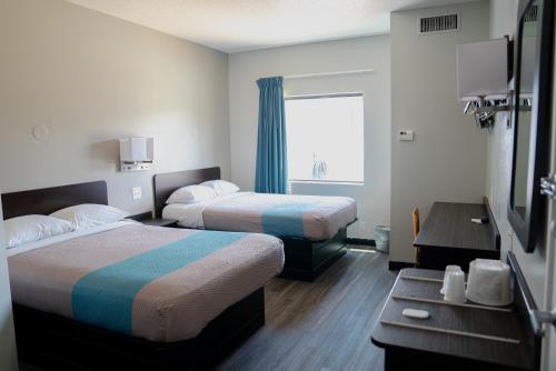 a hotel room with two beds and a window at Motel 6-Caseyville, IL - Caseyville Il in Caseyville
