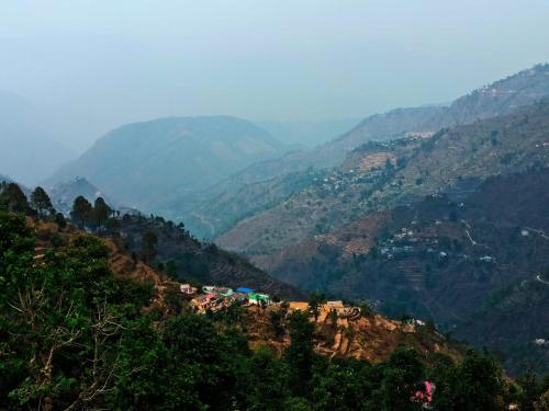 a view of a mountain valley with trees and houses at Peacock Homestay in Srīnagar