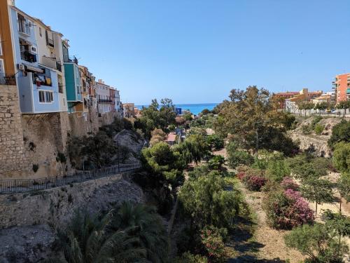 a view of a hill with houses and trees at La Muralla in Villajoyosa