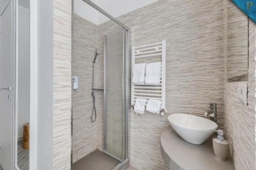 a bathroom with a sink and a glass shower at Piccolotel in Rome